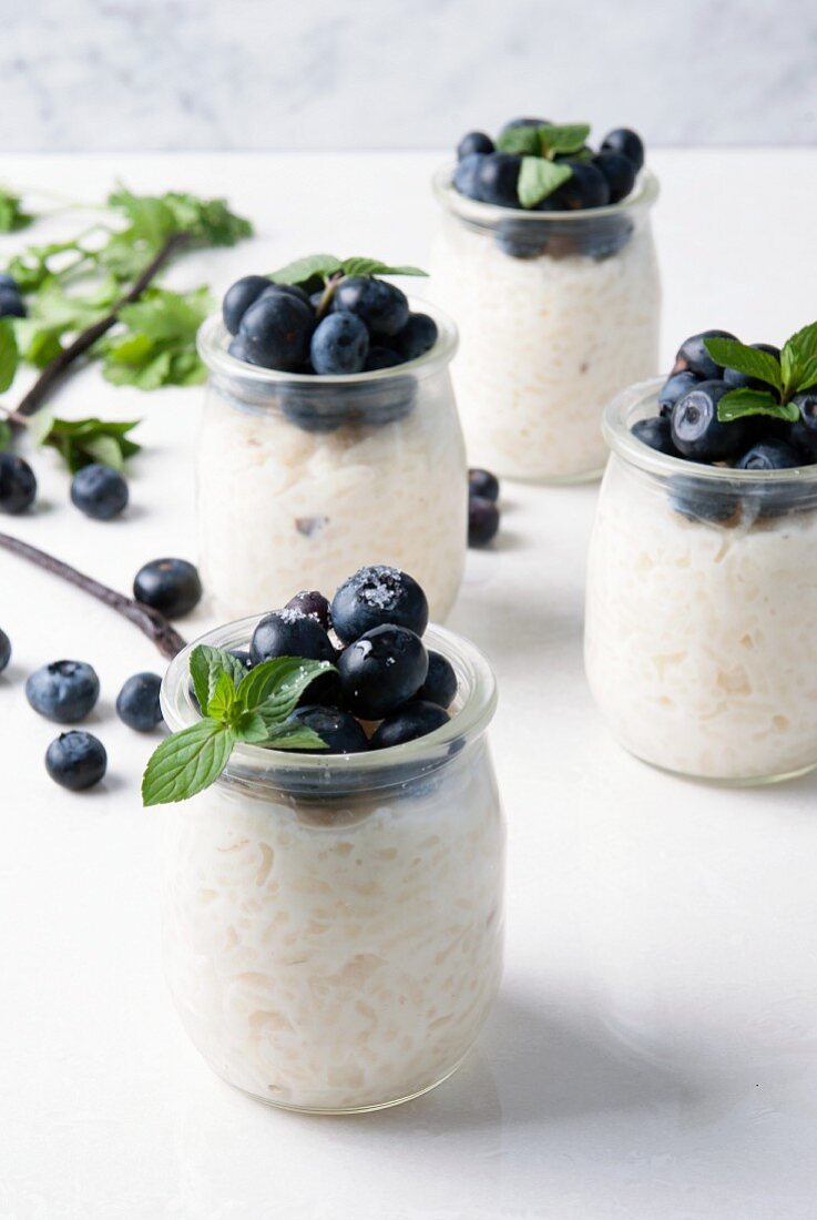 Rice pudding with blueberries in several glass jars