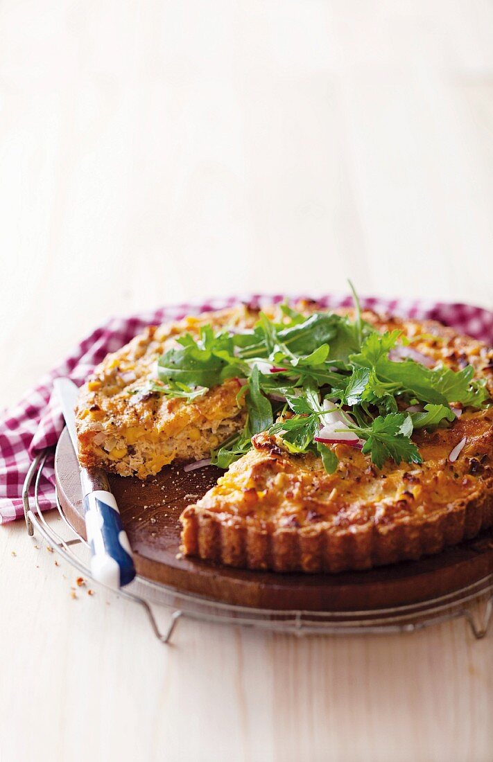 A quiche with sweetcorn, tuna, cheese, rocket and coriander
