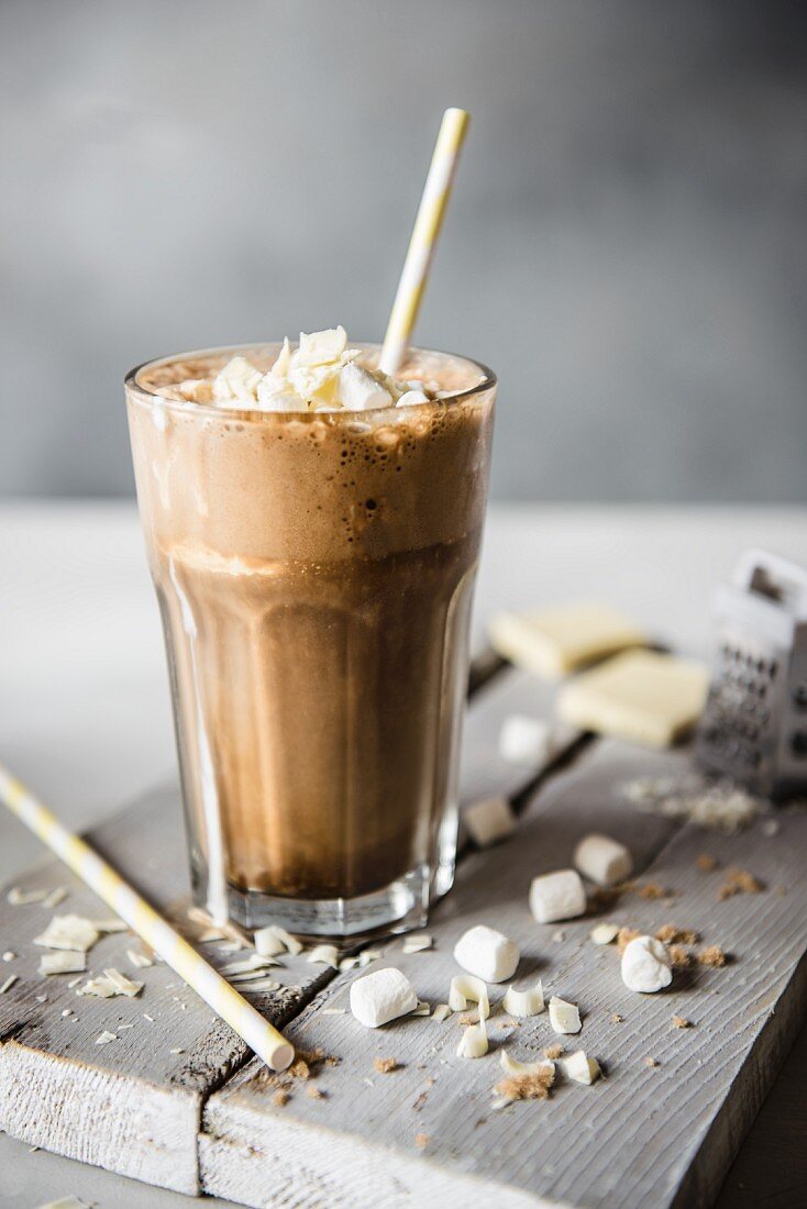 A glass of iced coffee with white chocolate and marshmallows