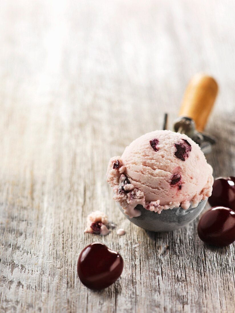 Cherry ice cream in an ice cream scoop