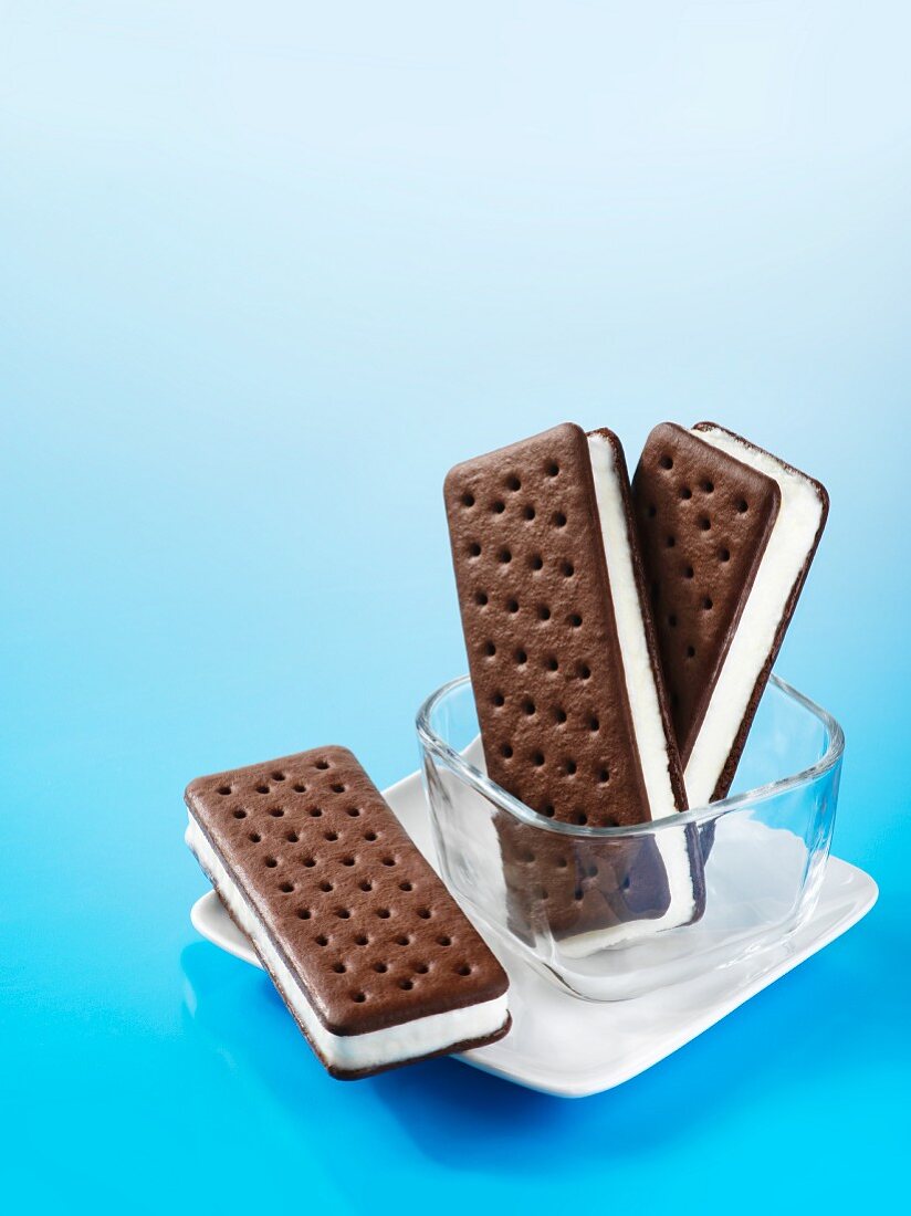 Ice cream sandwiches in a glass dish and on a plate