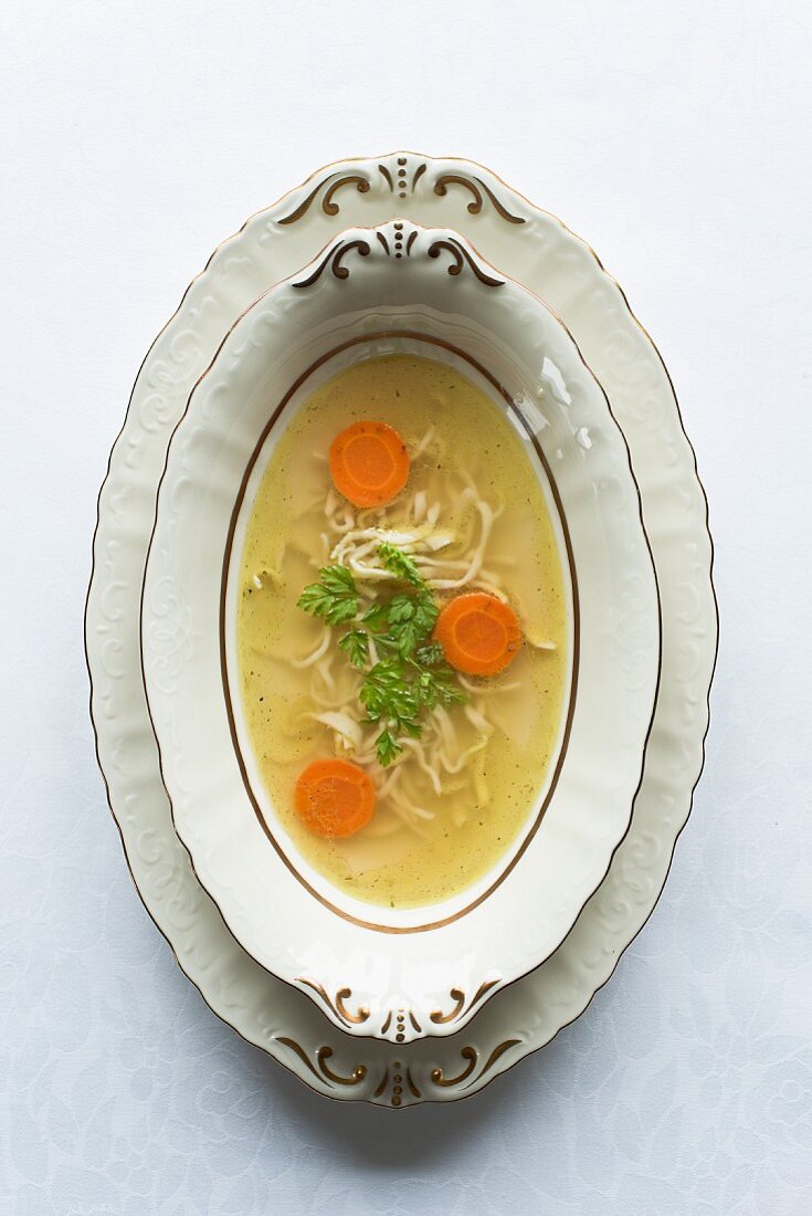 Clear chicken broth with noodles and carrots