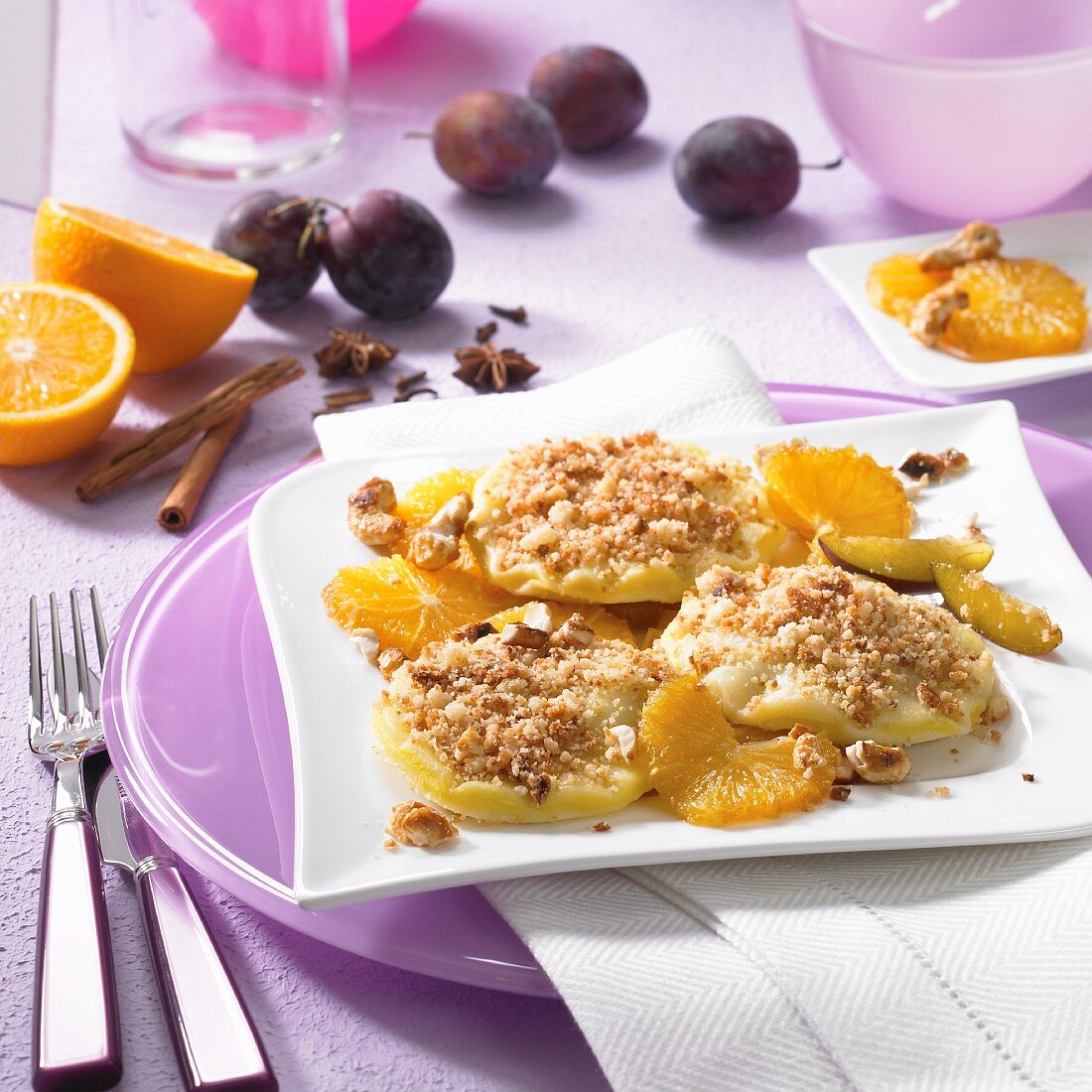 Powidltaschen (stewed plum pastries) with oranges, plums and nuts