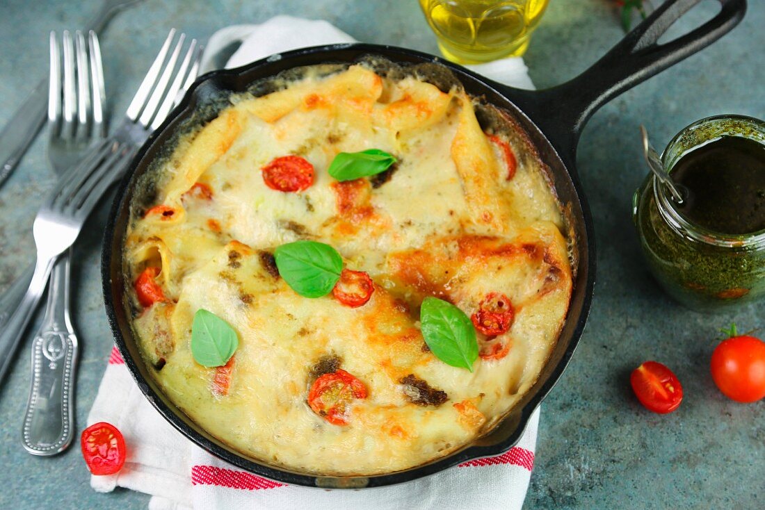 Lasagna with pesto and cherry tomatoes in a pan