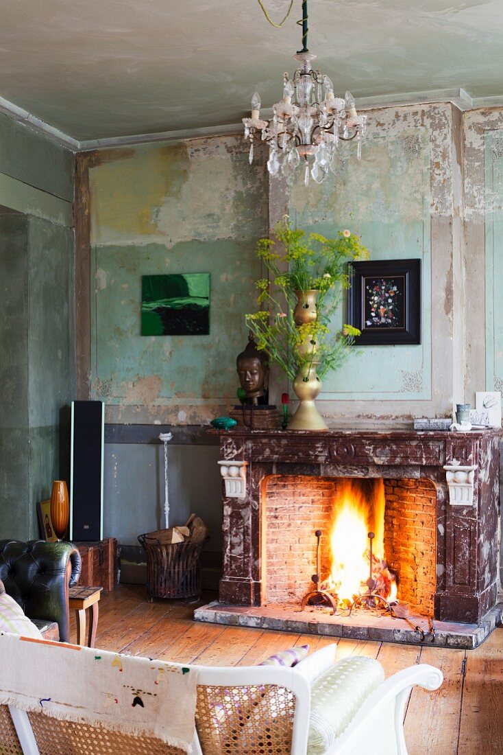 Open fire and flower arrangement in vintage interior