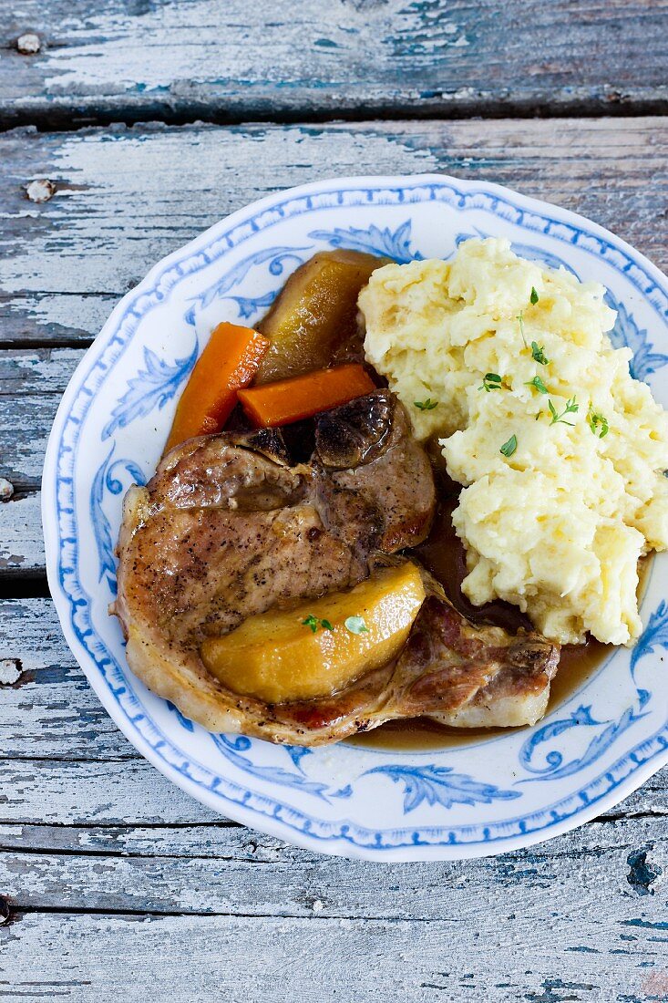 Pork chop with apple sauce and crushed potatoes