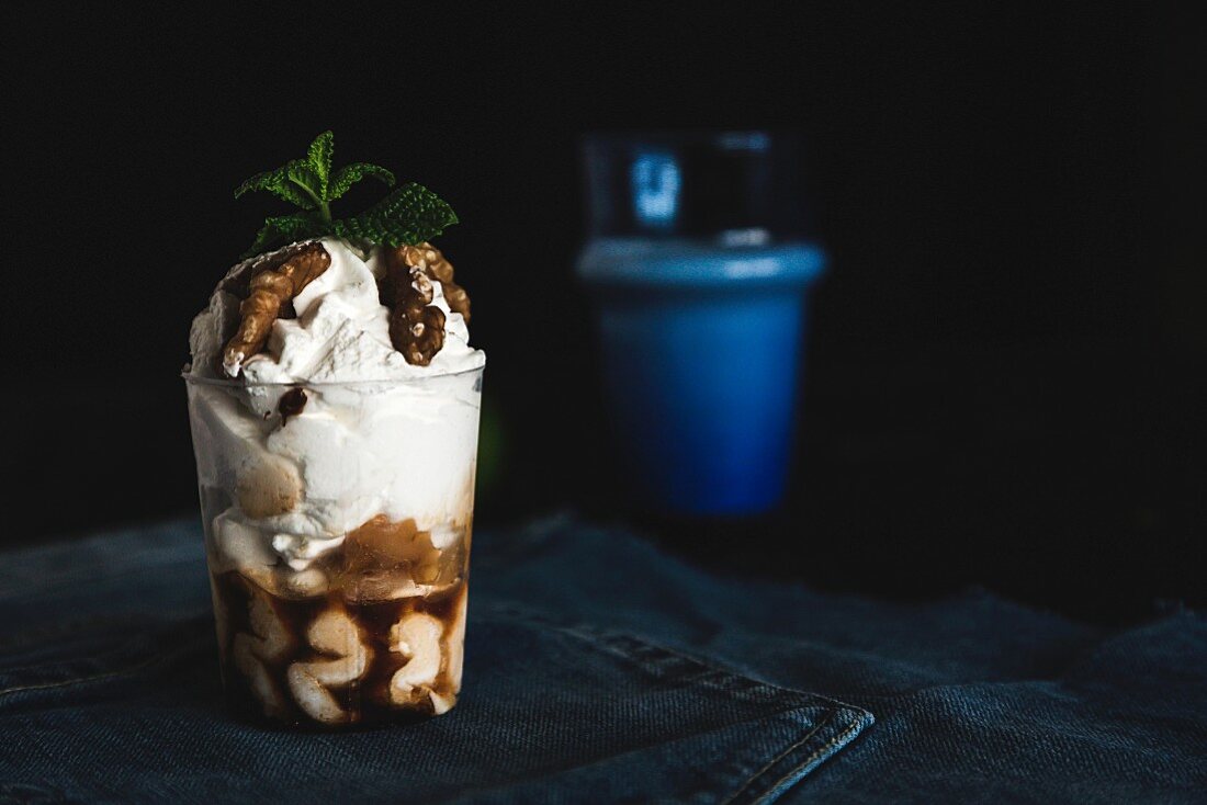 A cake sundae in a glass with walnuts and mint