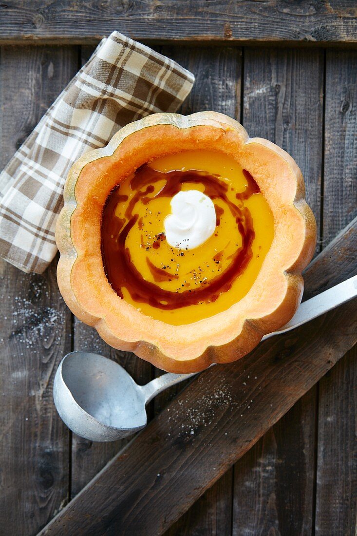 Cream of pumpkin soup in hollowed-out pumpkin