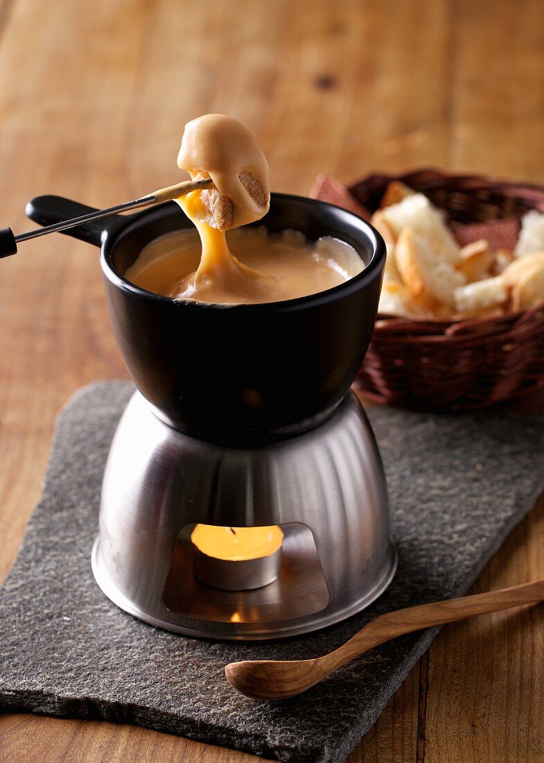 Cheese fondue with bread cubes