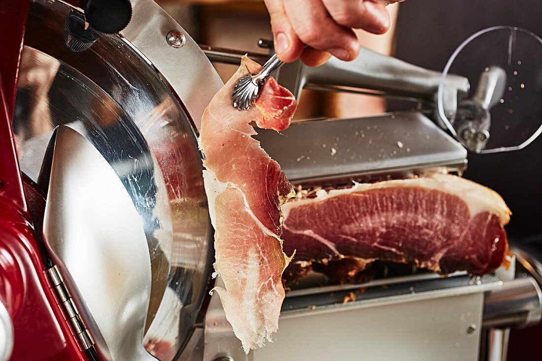 Ham being sliced in a slicing machine