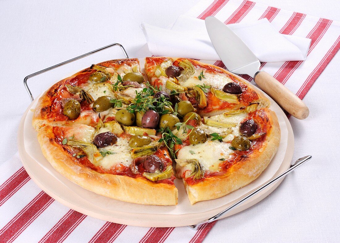 A pizza with olives and artichokes