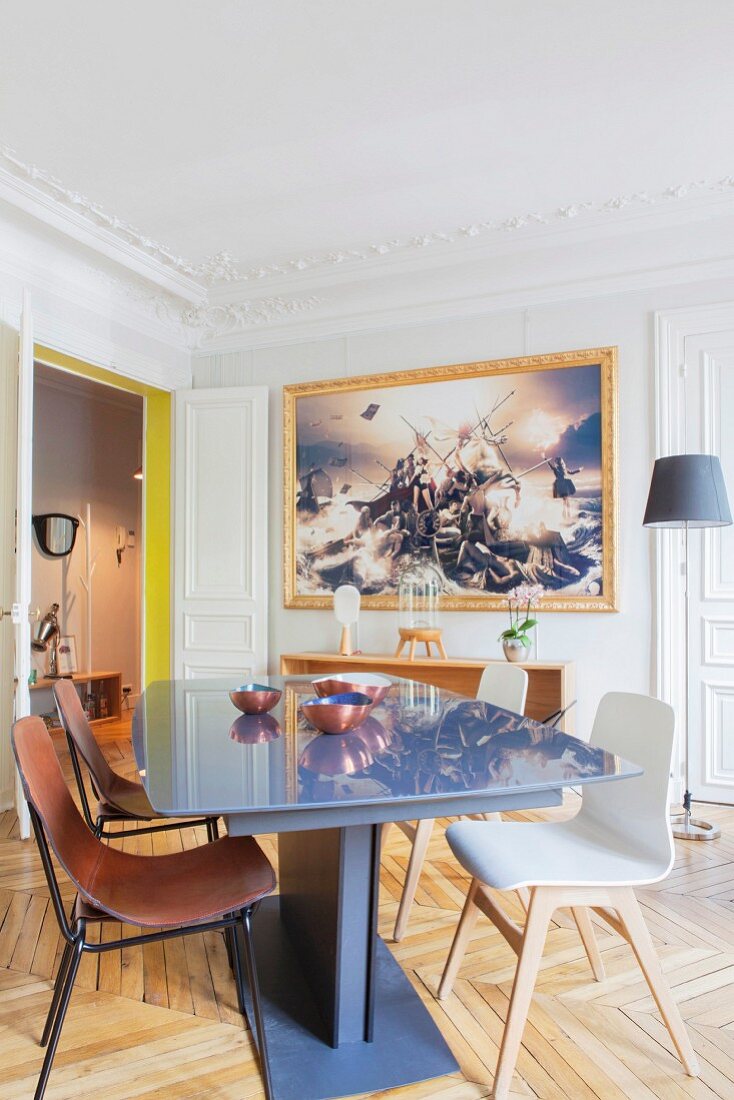 Dining area in restored period apartment with herringbone parquet floor