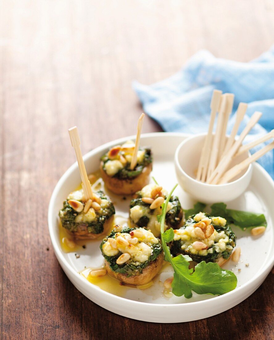 Mushrooms filled with with spinach, feta, pesto and pine nuts