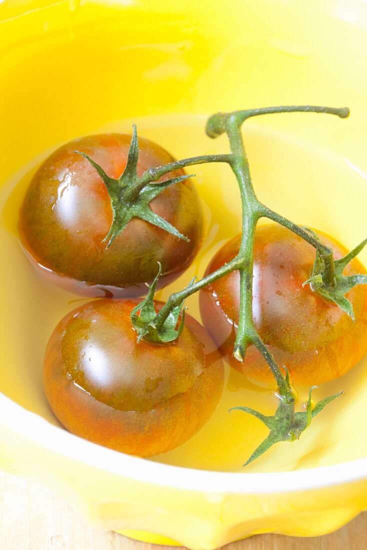 Vine tomatoes in a bowl of water