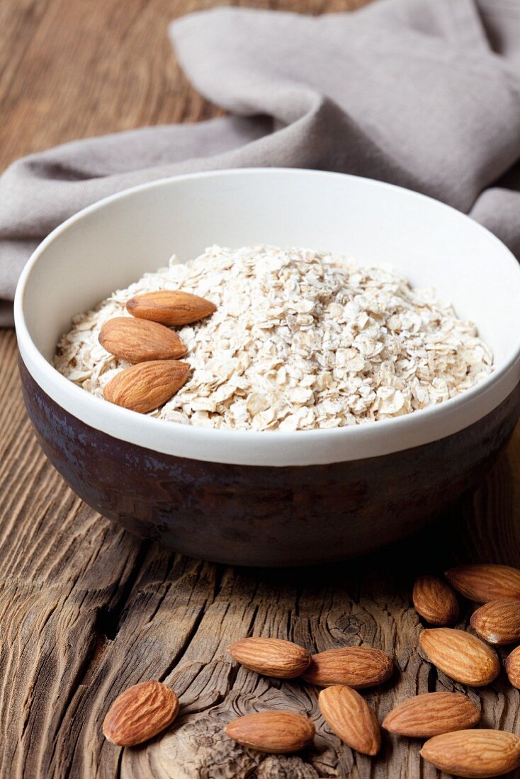 Porridge oats and almonds in a ceramic bowl