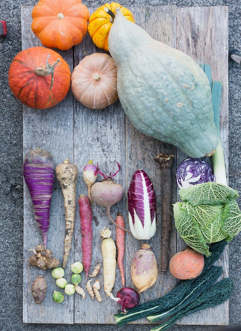 Assorted winter vegetables on a wooden board