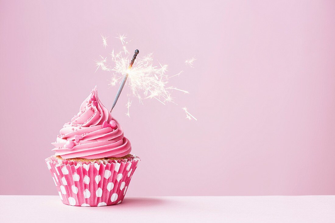 Pink cupcake decorated with a sparkler