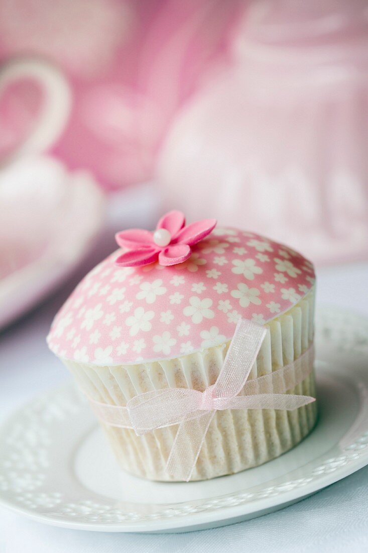 Cupcake mit gemusterten Fondant und Zuckerblüte dekoriert