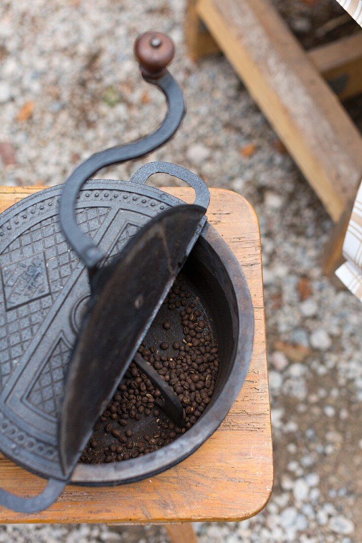 An old coffee roaster with coffee beans