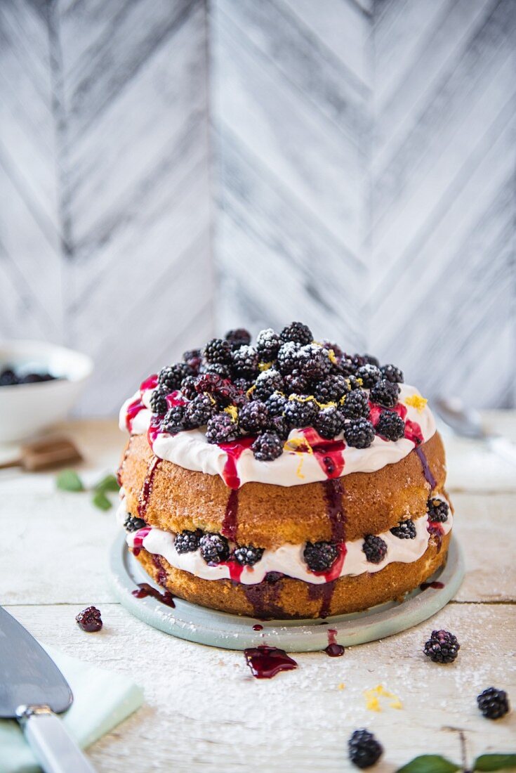 Blackberry & lemon cake with cream and blackberry sauce