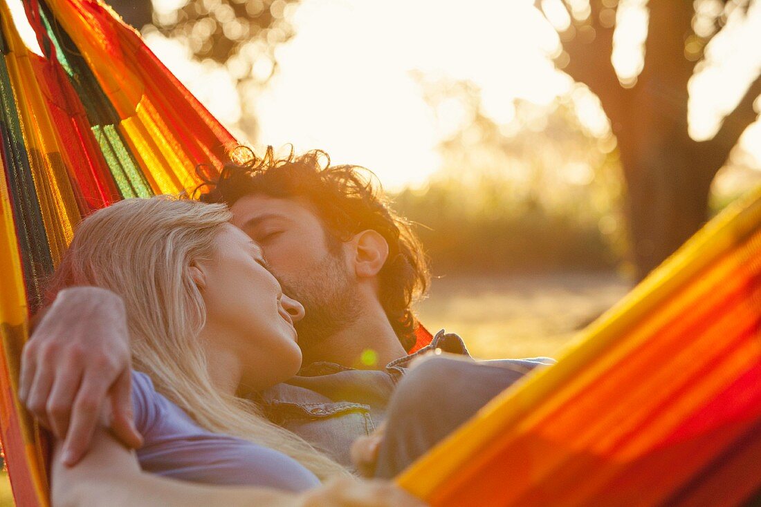 A couple cuddling in a hammock