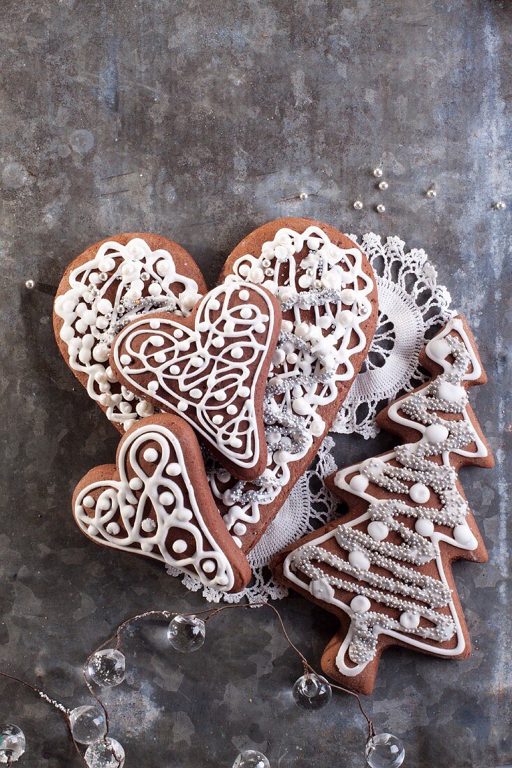 Christmas gingerbread Christmas tree and heart biscuits on a lace doily