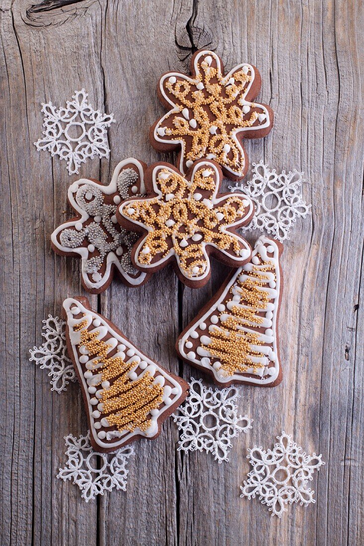 Christmas gingerbread biscuits (in the shape of stars and bells) on a wooden surface