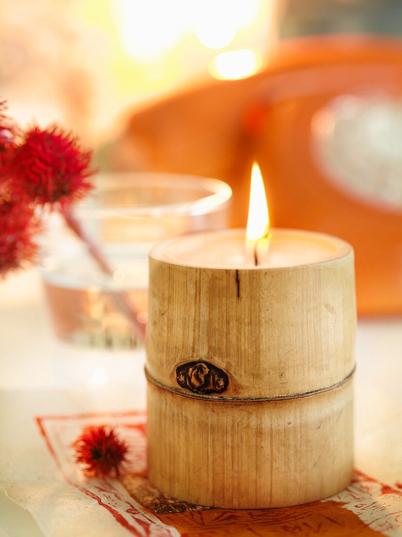 Lit candle inside bamboo stem