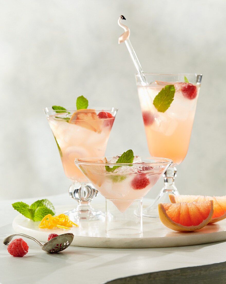 Paloma cocktails with grapefruit, raspberry, mint and ice