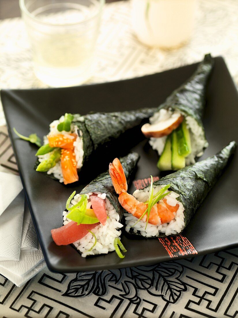 Temaki sushi on a black plate