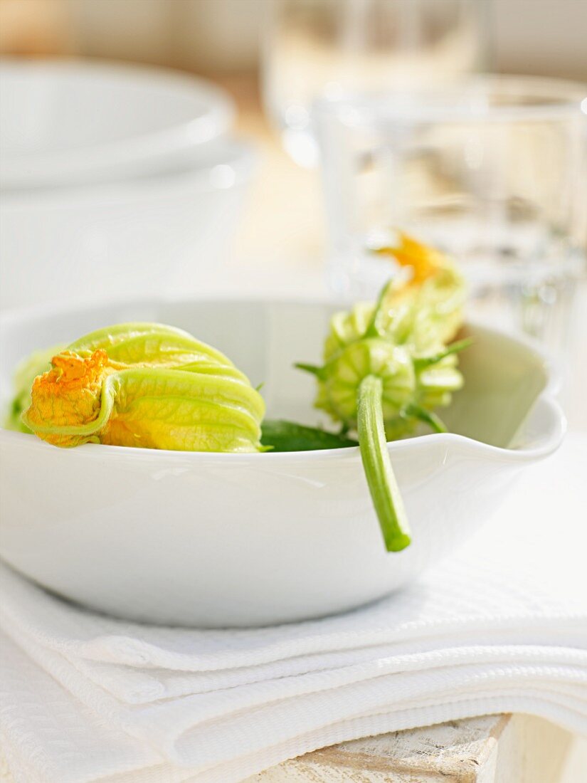 Courgette flowers in a white bowl
