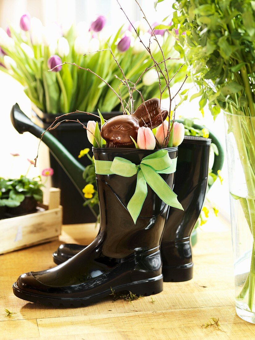 Chocolate Easter bunny and tulips in black Wellington boots