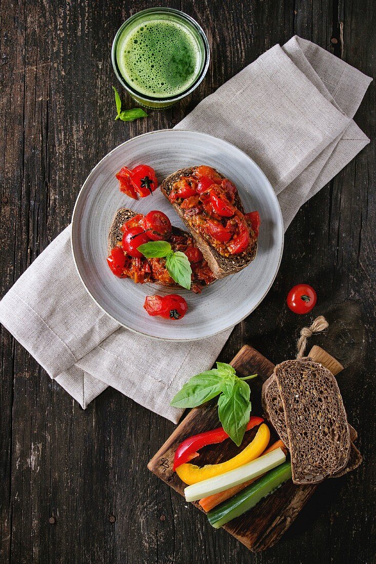 Italian tomato bruschetta with baked cherry tomatoes and sliced vegetables