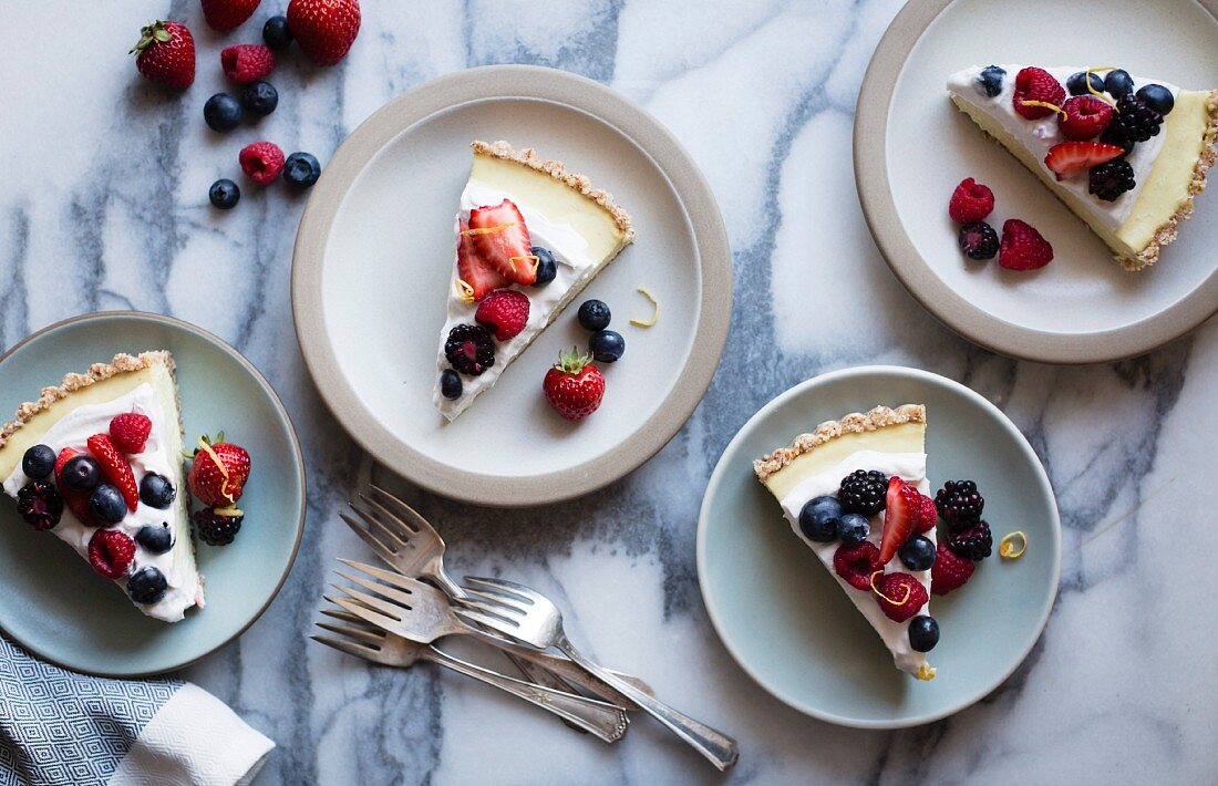 Sliced No-Bake Lemon Berry Coconut Cream Tart with fresh berries (vegan, gluten-free, refined sugar-free) on plates