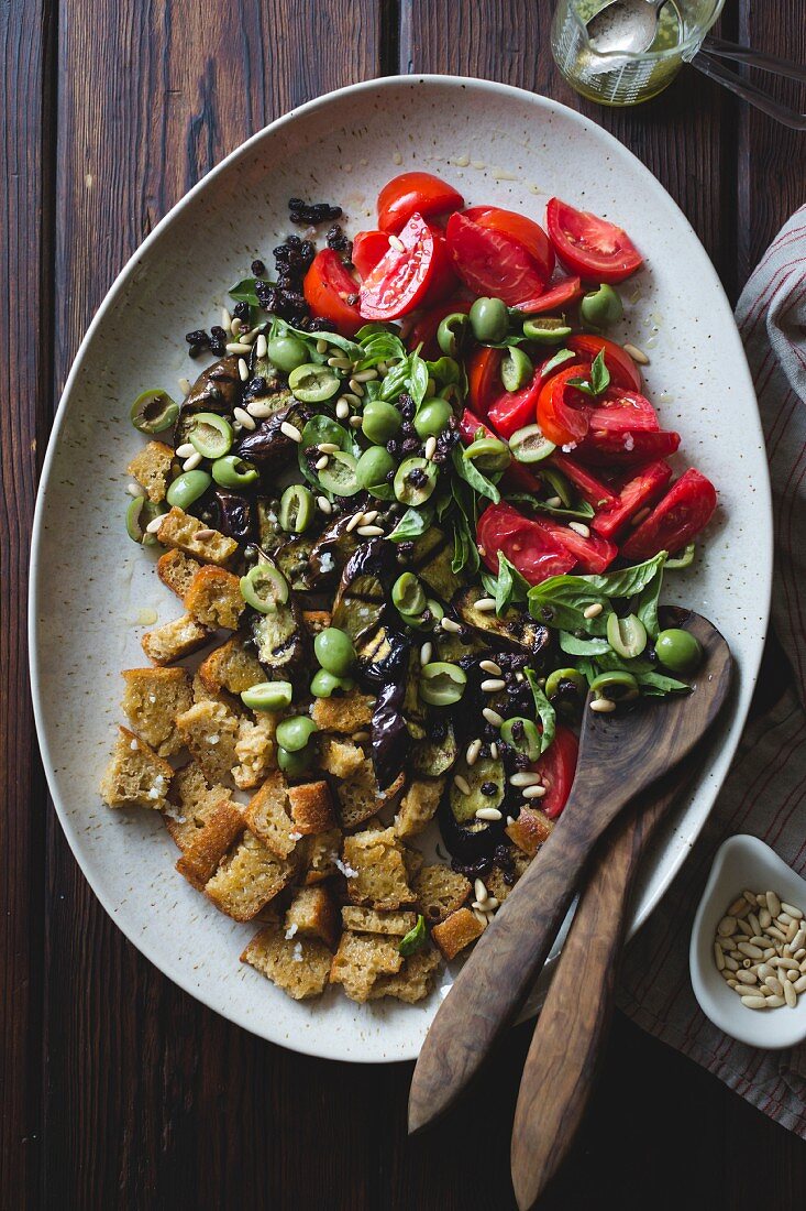 Panzanella with roasted aubergine, capers, olives and pine nuts (gluten-free)