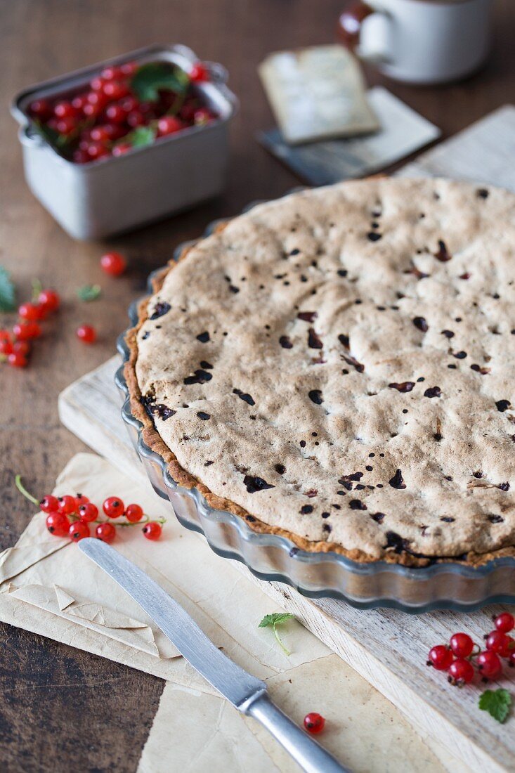 Redcurrant & almond tart in a baking tin