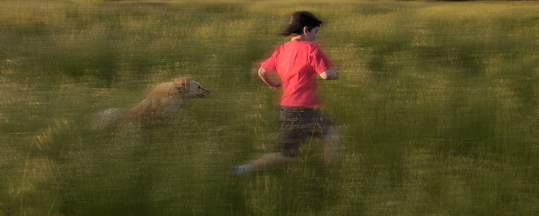 Boy Running Through Grass