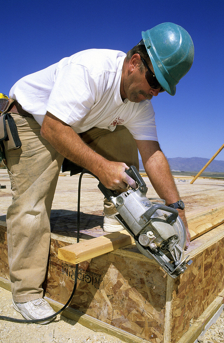 Carpenter Cutting Lumber