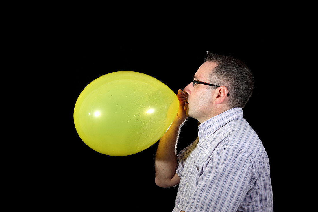 Man Inflating Balloon