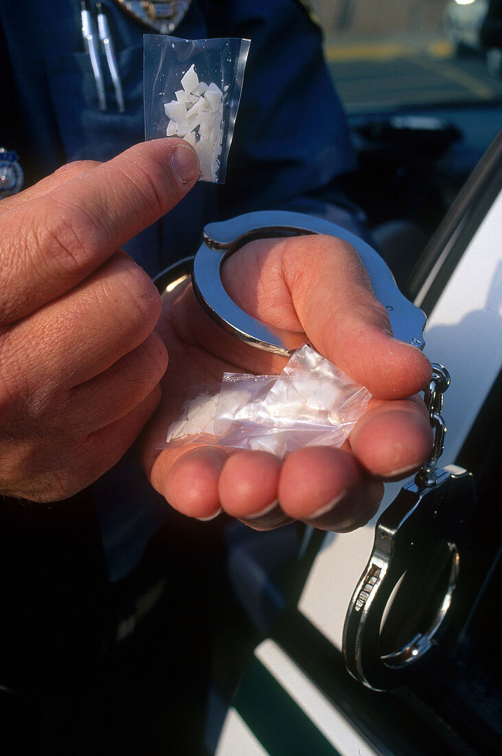 Cop Holding Crack Cocaine and Handcuffs