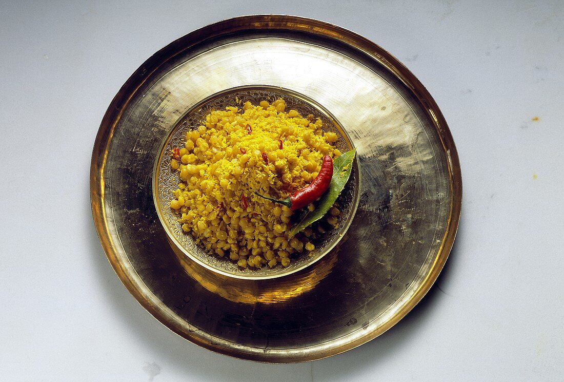 A Bowl of Split Peas with Coconut on a Tray; Chili Pepper