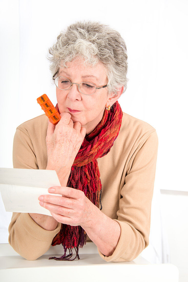 Older woman taking pills