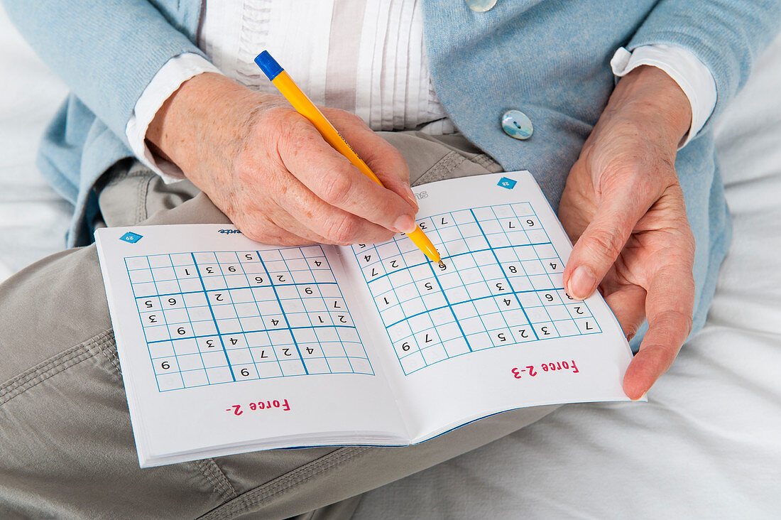 Older woman doing Sudoku