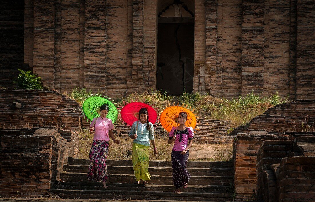 novice Buddhist monks with parasols