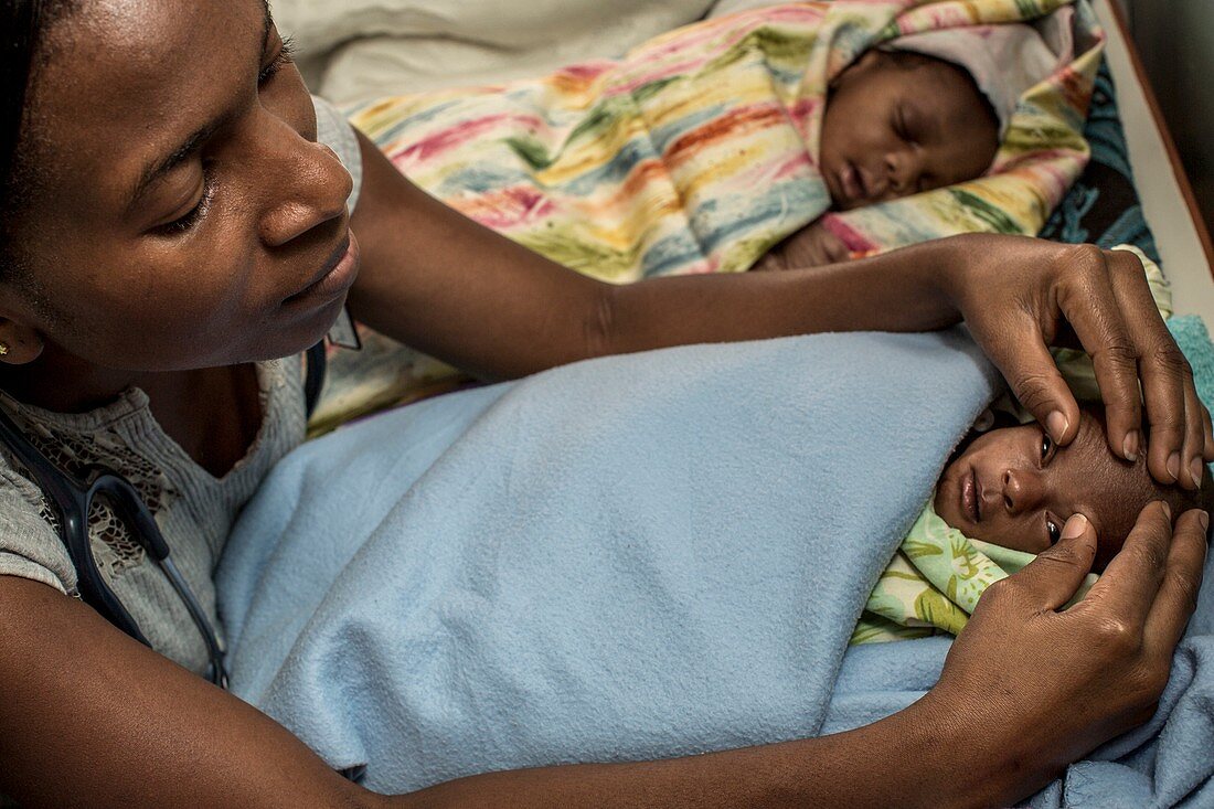 Hospital doctor examining baby's eyes