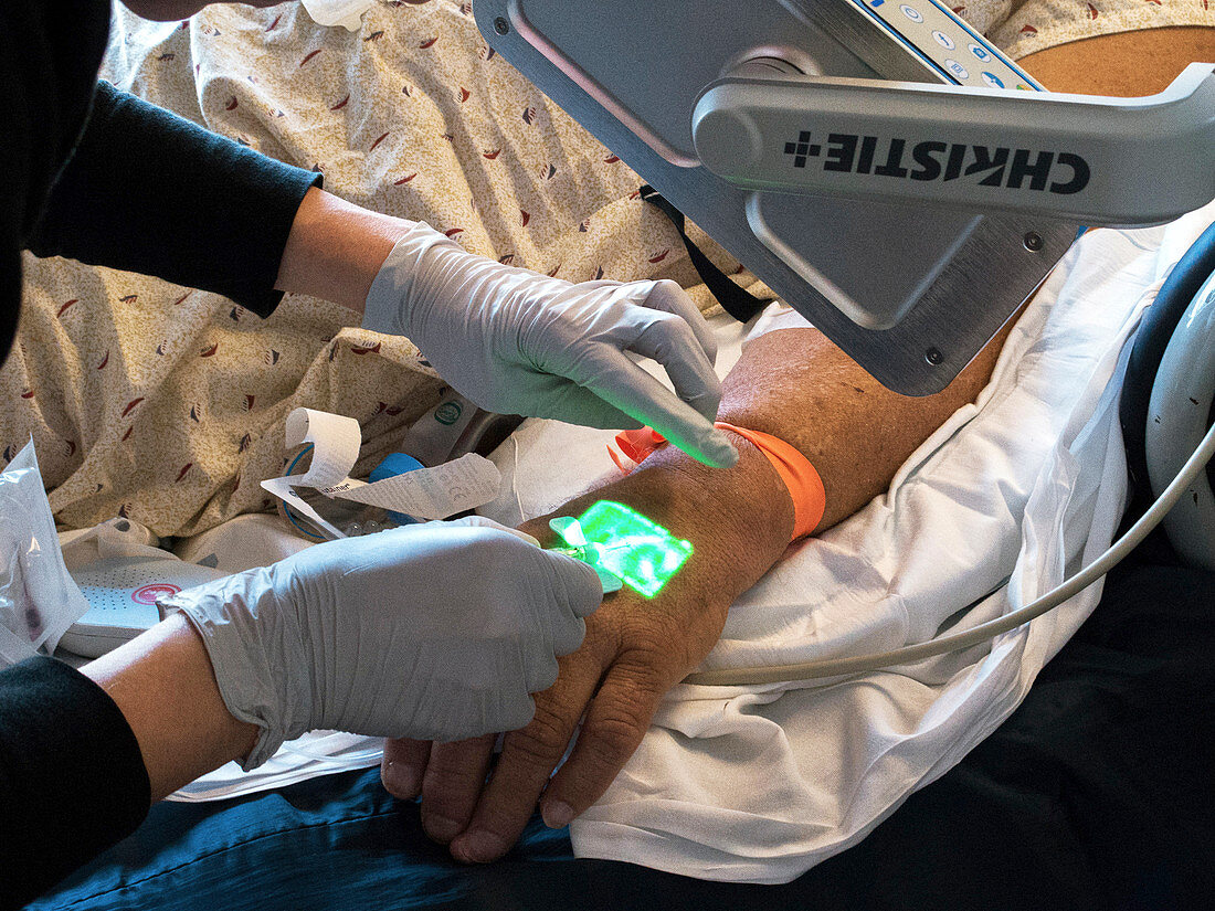 Nurse using infrared vein-finding device