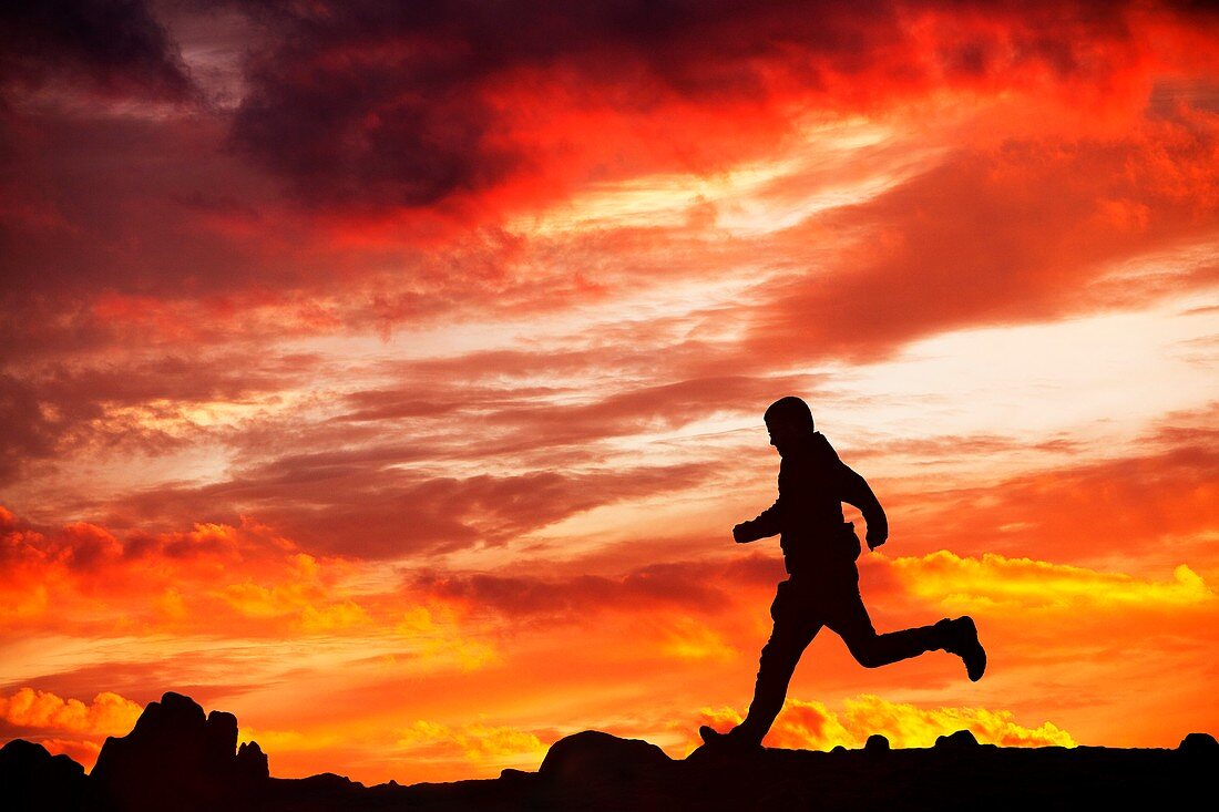 Man running against sunset