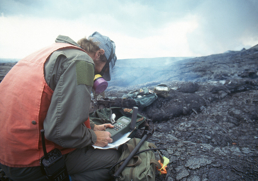 Volcanologist recording position of fumarole