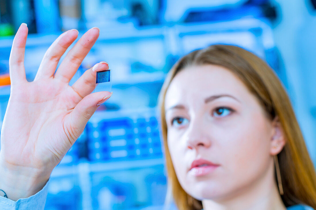 Lab technician holding a lab on a chip