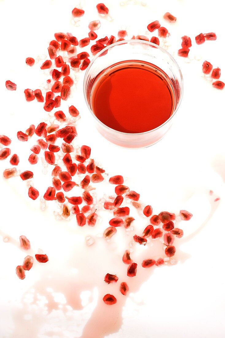 Red berries and glass with red juice